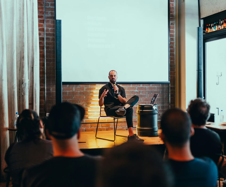 Speaker engages an audience during a business seminar in a modern conference room.